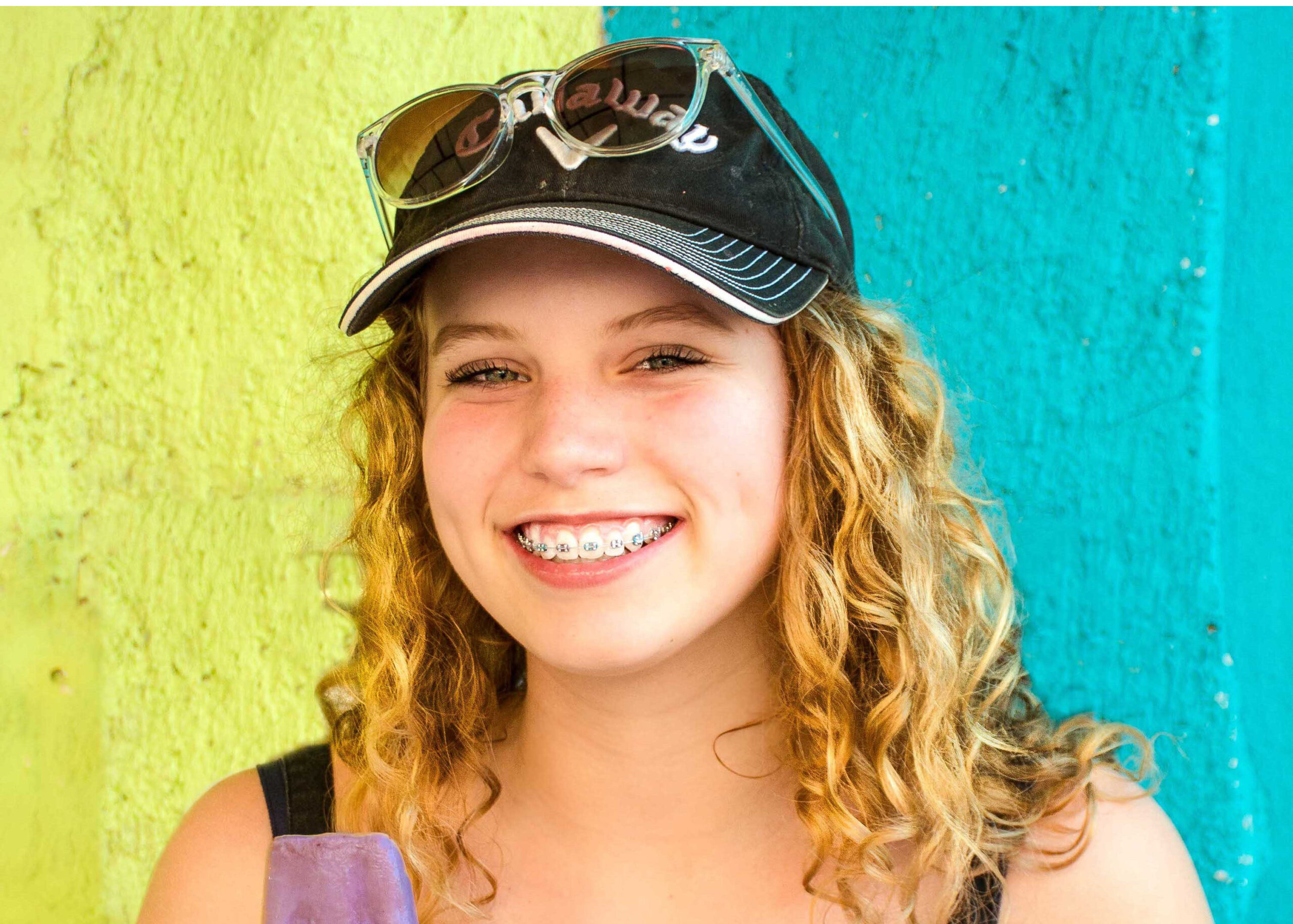 Teen in hat shows off her braces